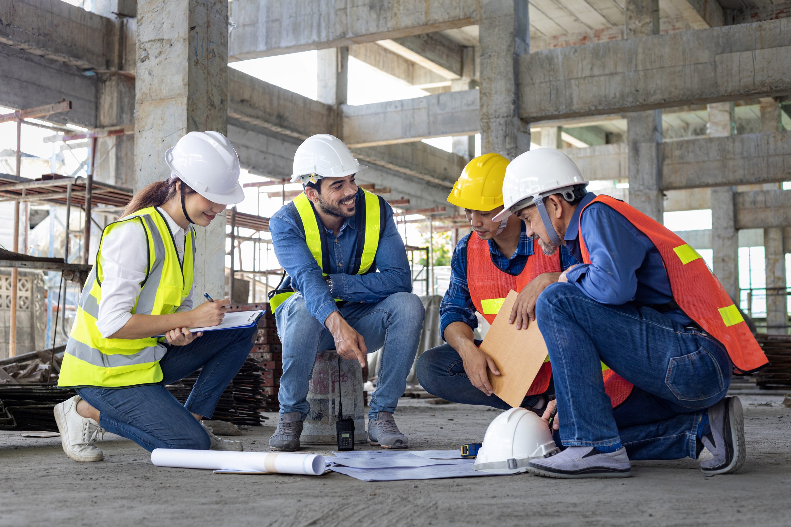 Team of engineer, architect, contractor and foreman meeting and consulting at construction building site with floor plan for real estate development project industry and housing timeline